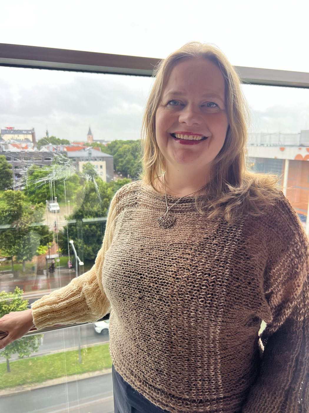 Paula, the designer behind Vastalanka, wearing her own beige Hali pullover