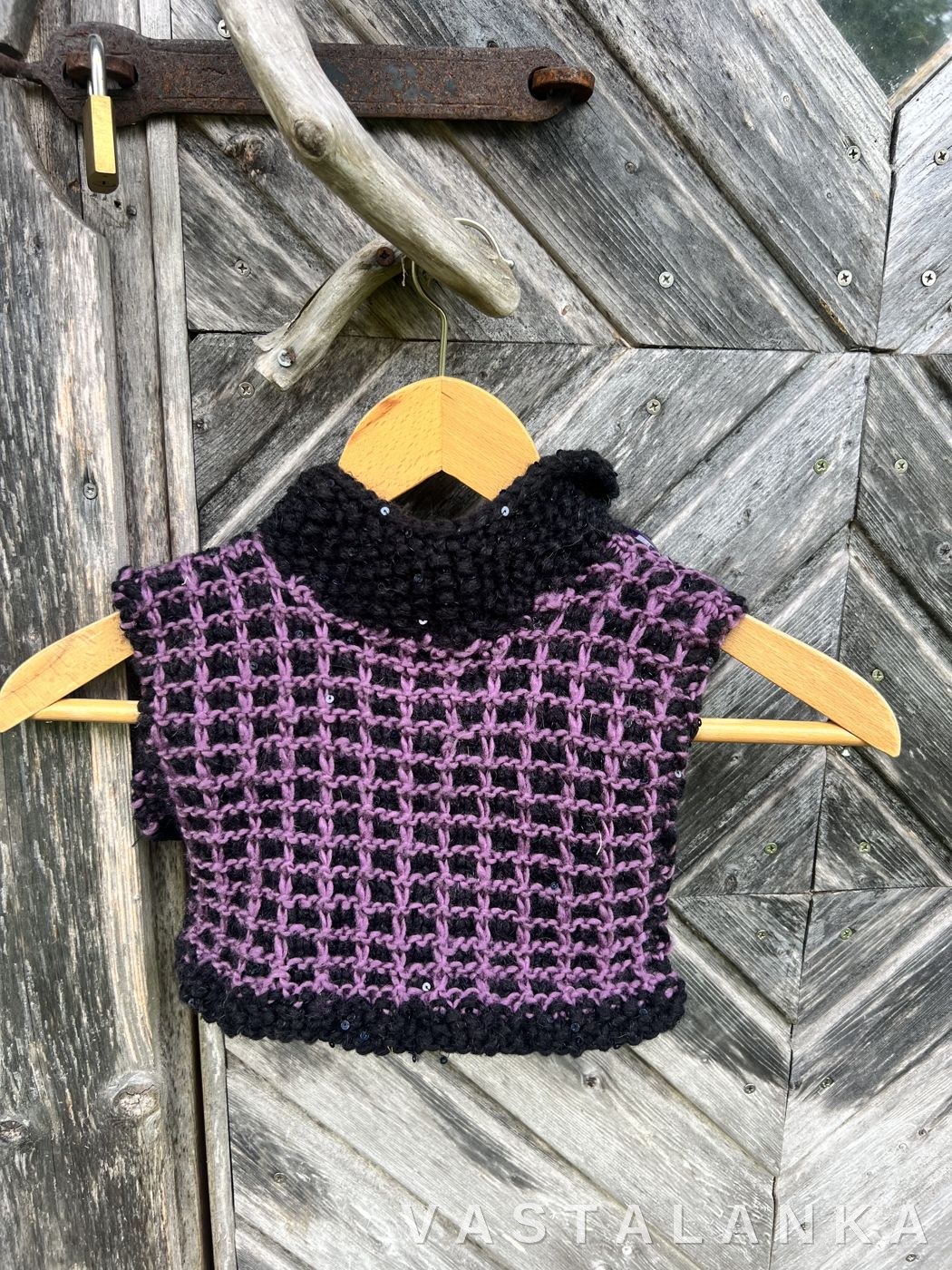 Vohveli adult cowl with reflector detail on a wooden hanger